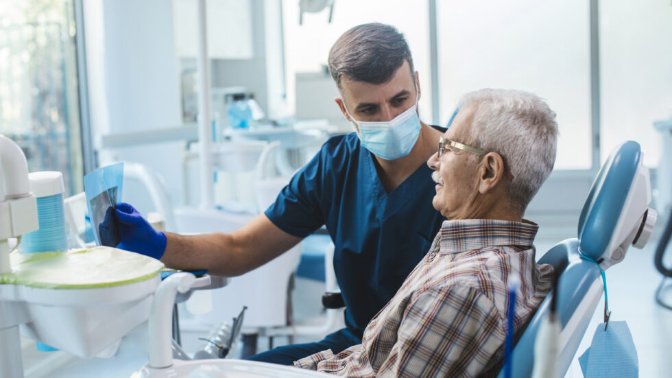 Dentist examining elderly patient